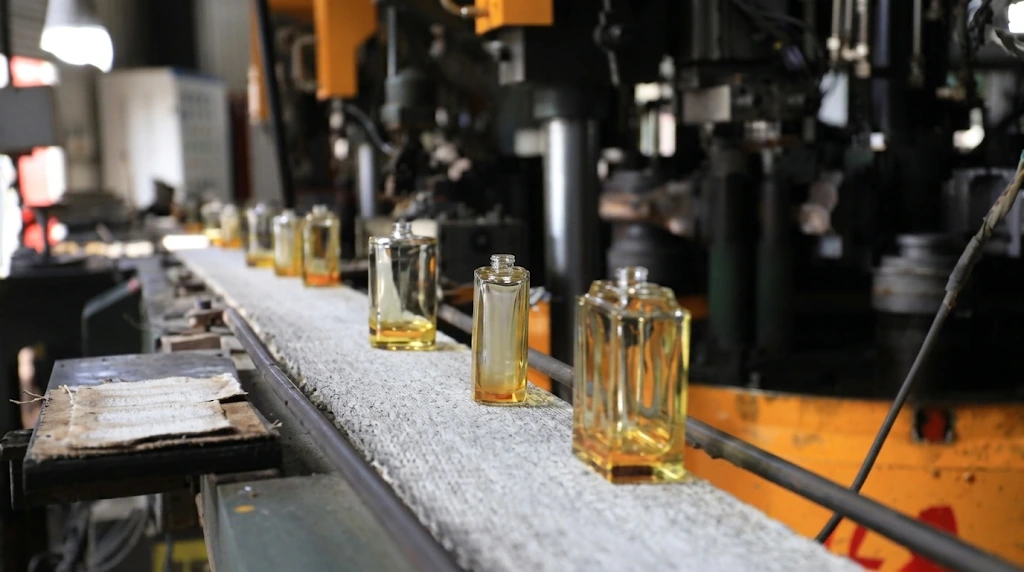 Glass bottles moving on a factory conveyor line
