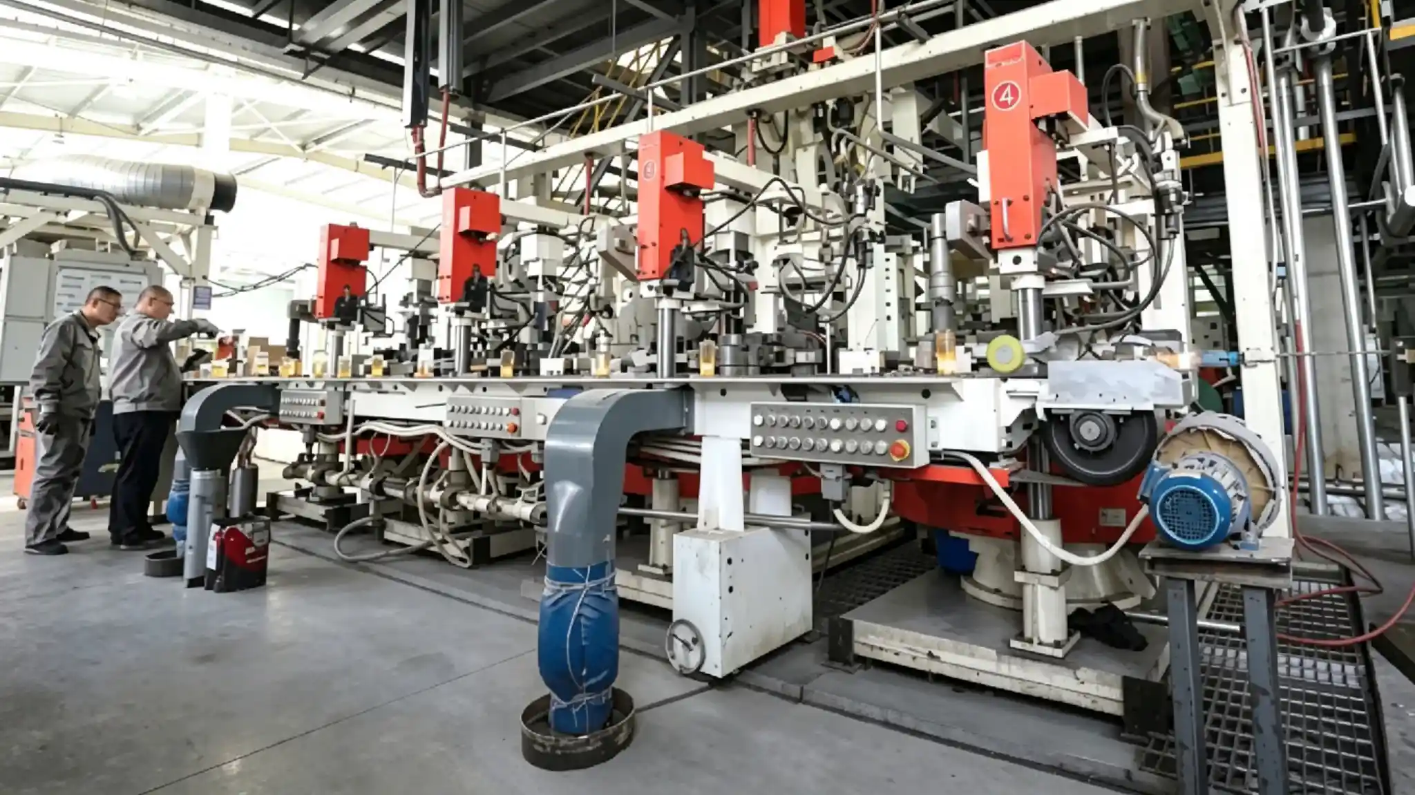 Workers checking glass production equipment